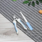 Pet owner trimming dog’s nails using ergonomic nail clippers – ideal for grooming salons and retail use