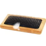 Close-up view of bamboo fine-toothed pet needle comb teeth and smooth wooden handle