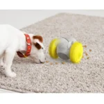 10004 Dog playing with robot shaped interactive tumbler toy food dispenser