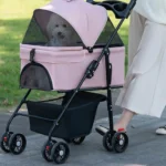 10005 Pet owner walking dog in deluxe foldable stroller with 4 wheels in an outdoor park