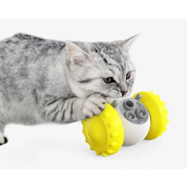 10006 Cat pawing at interactive robot pet toy to release treats