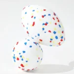 Close-up of textured surface and durable TPR material of rugby-style dog ball