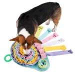 06883c1dca6d33f1aa79e43c9e9322d5 Dog sniffing and playing on colorful snuffle mat – interactive enrichment toy